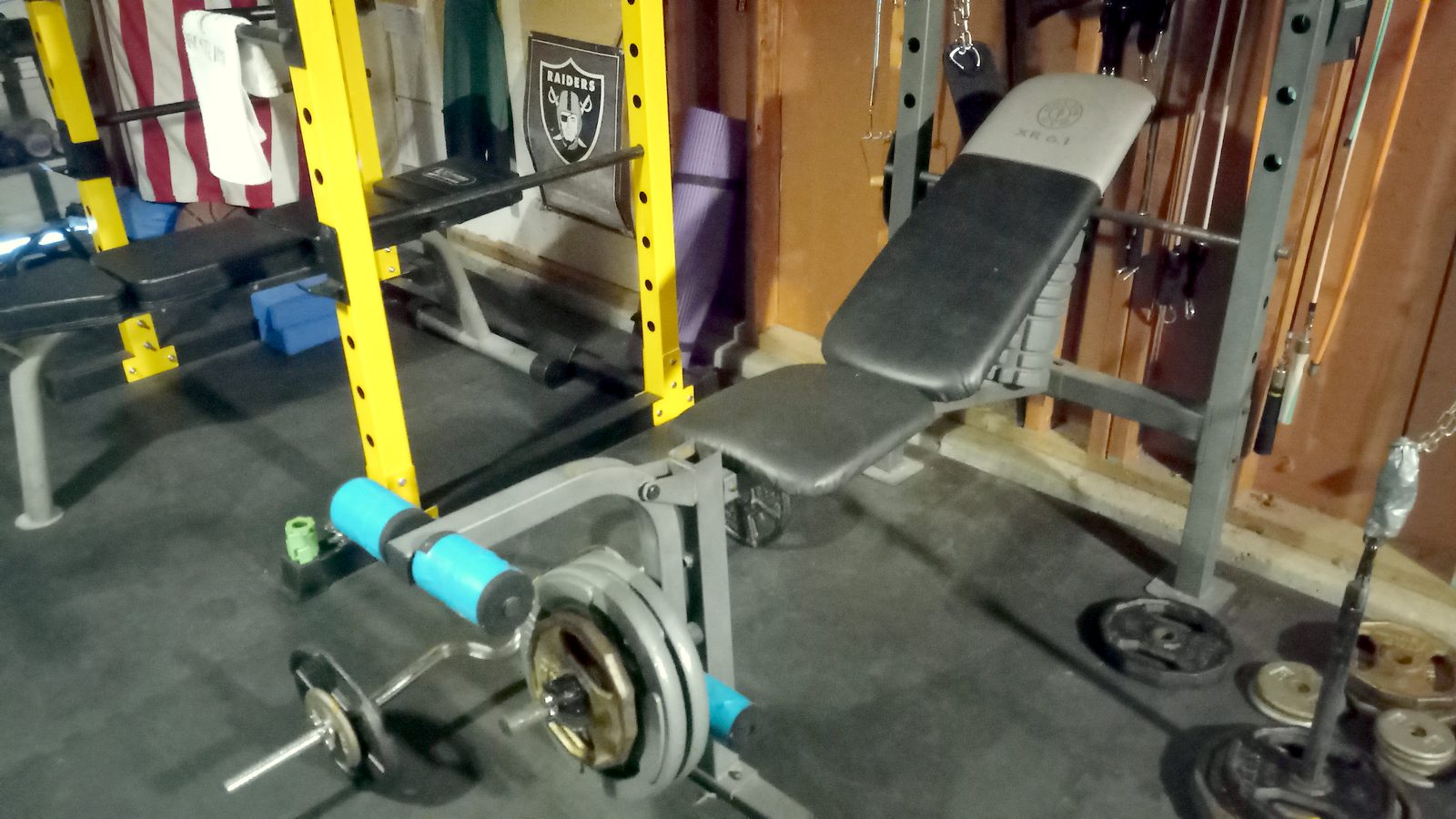 Adjustable bench and weight plates in the garage gym