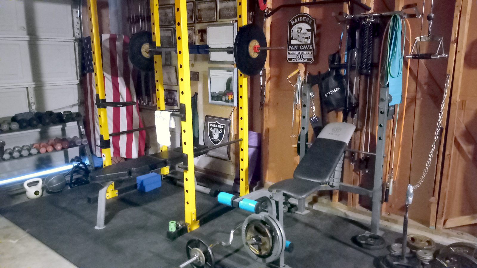 Garage gym overview with power rack, bench and plates