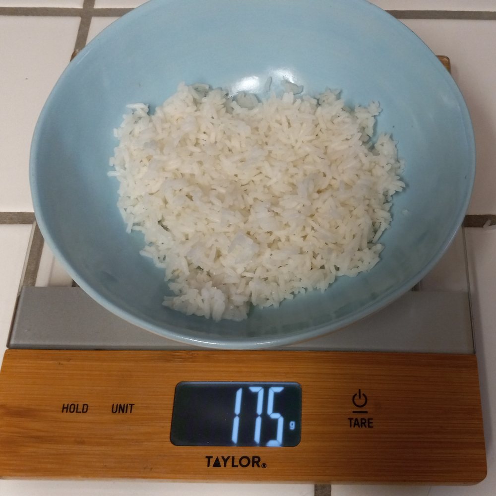Rice weighed on a food scale for meal prep, 175 grams